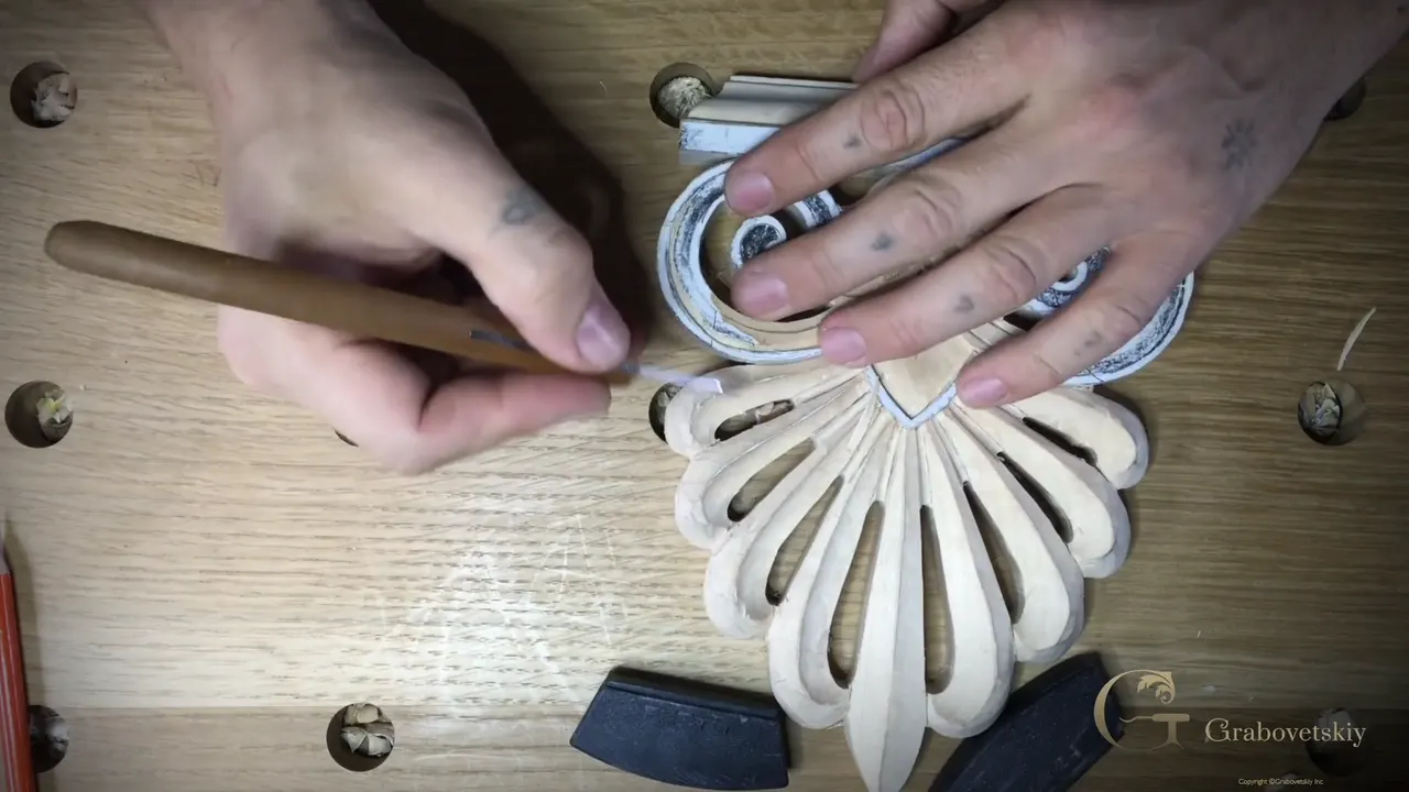 Knife laid low along the spiral, the other hand holding the board steady