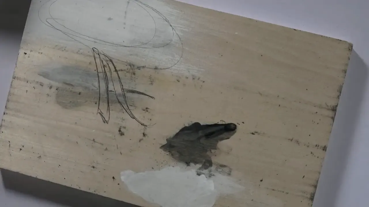 Pencil letter drawn with two lines per stroke on a painted practice board