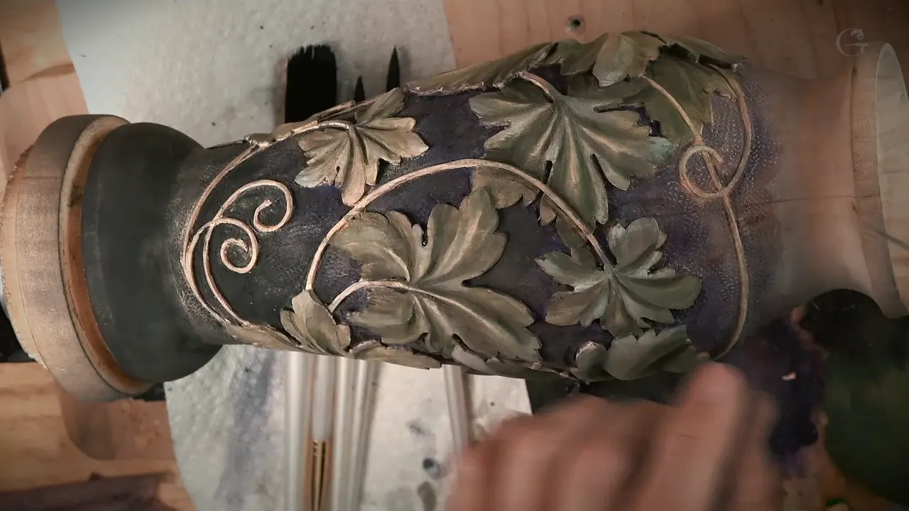 The colored grape leaf vase, gold vines curling over purple and black