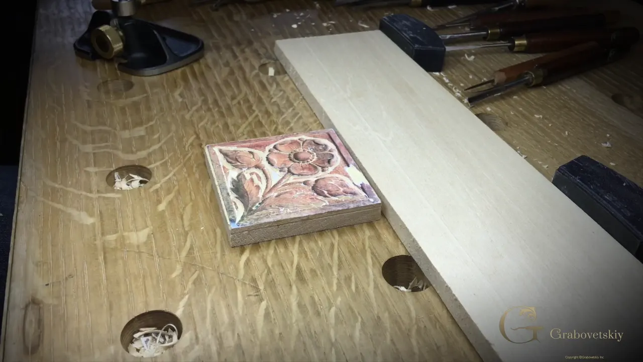 Small black router plane resting on the bench beside the outlined rosette and a long pale strip of spare wood.