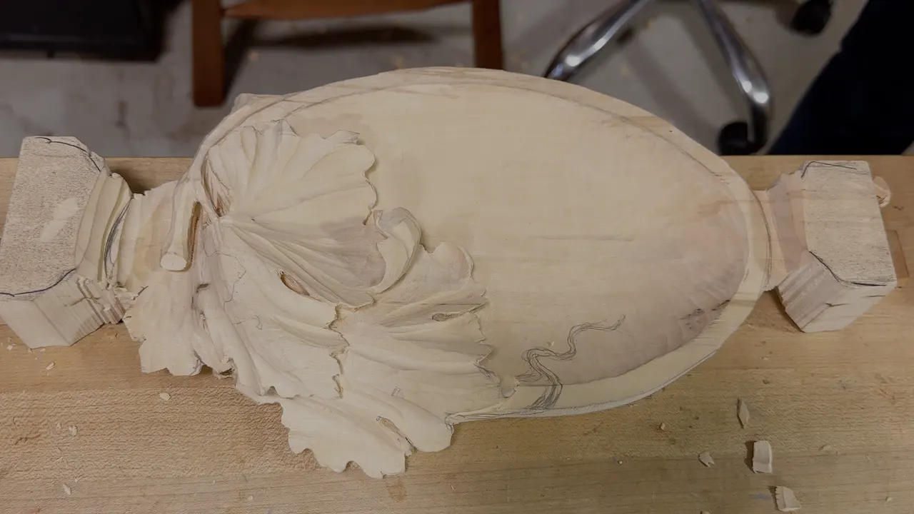 Tray on the bench, the leaf carved at one end and a pencil curl drawn across the bowl