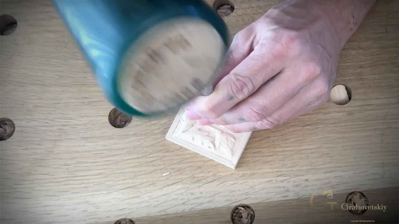 A green mallet blurs down toward the rosette
