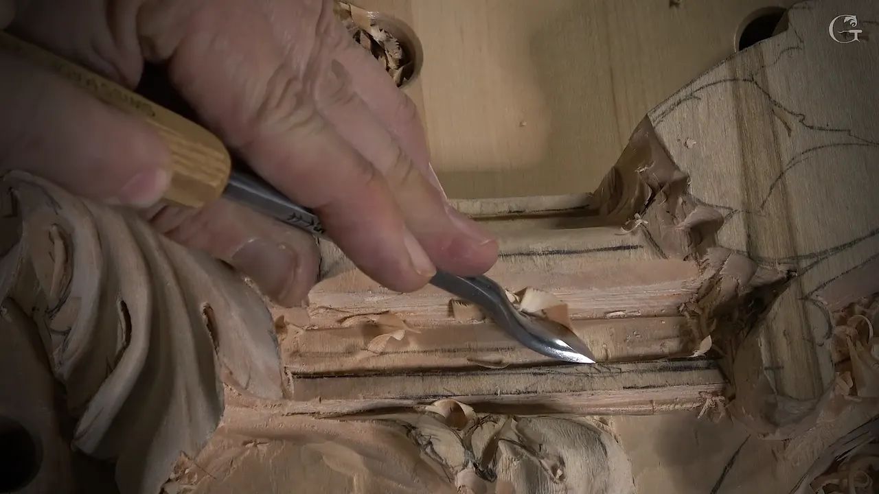 Held low in the fingers, a back bent runs along a narrow molding strip with curls of wood
