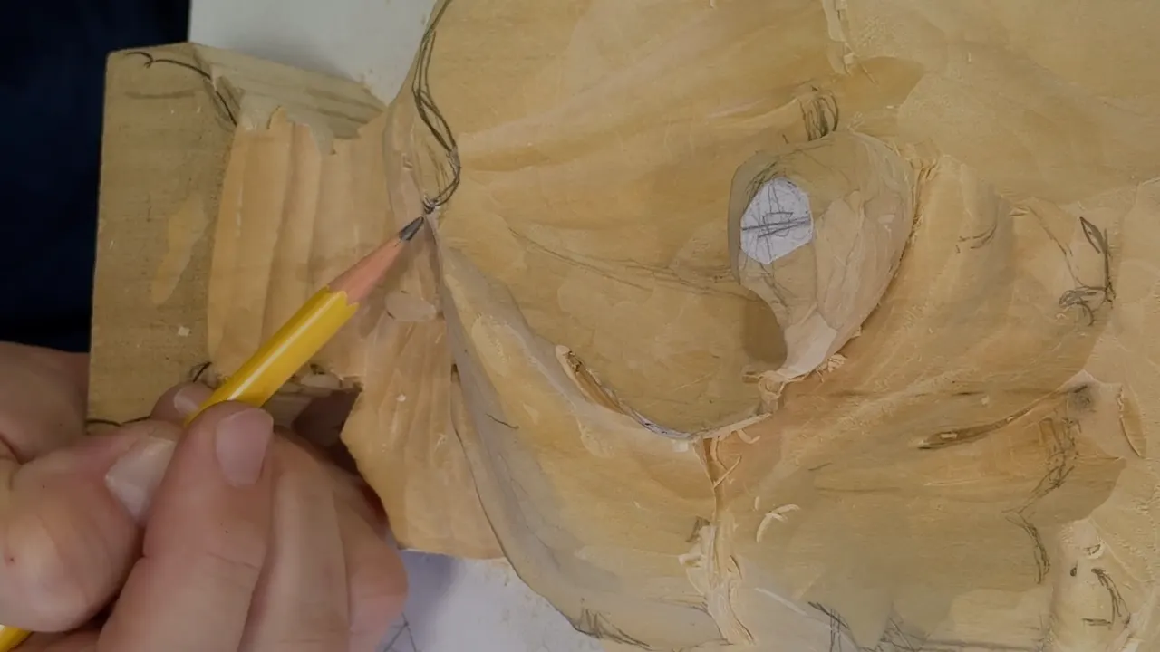 Pencil point resting where the grooved block at the left meets the leaf