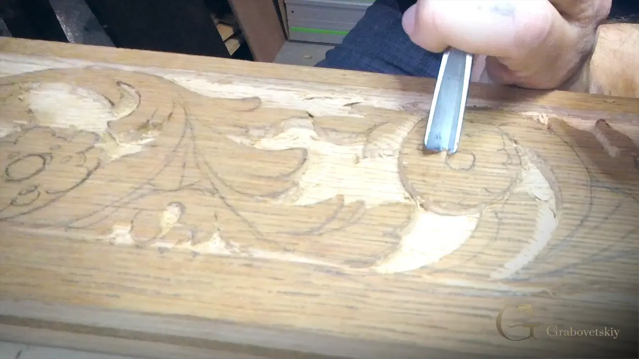Inside the outlined circle of an oak flower a V tool rests, the background already lowered around it